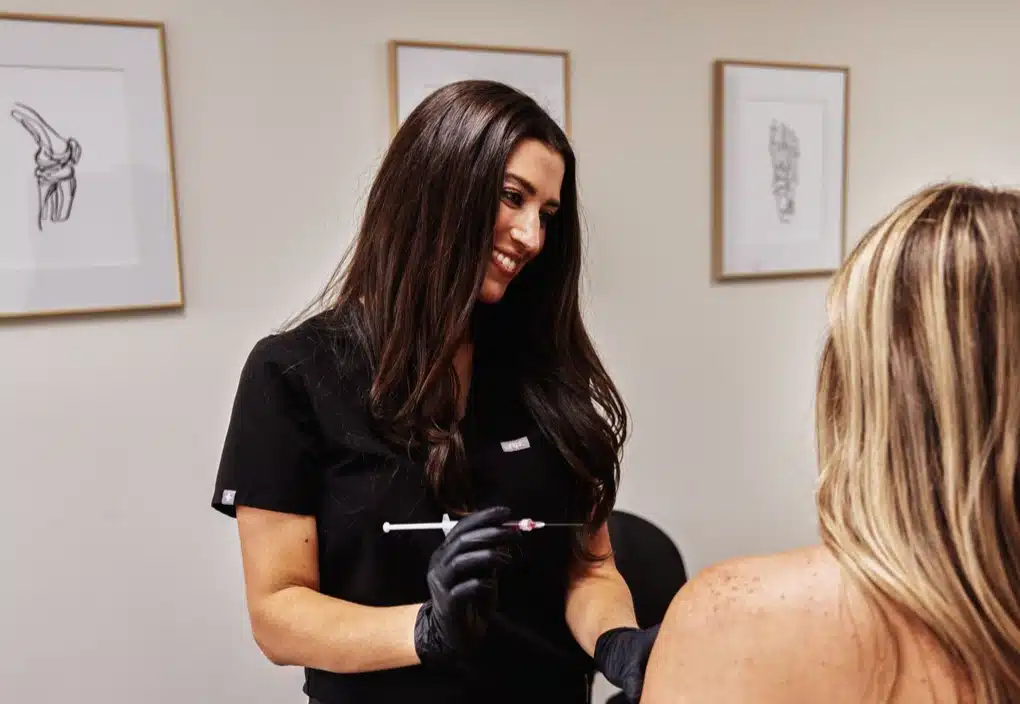 Clinician gives injection at Renew Health and Wellness.